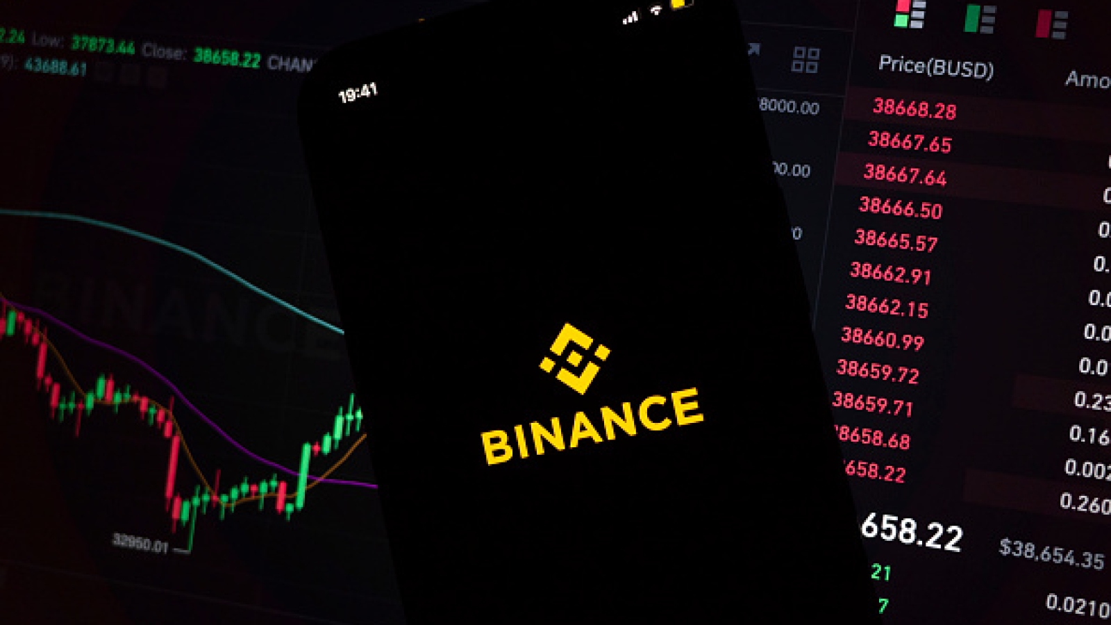 In this photo illustration, an iPhone displays the app and logo of popular cryptocurrency exchange platform Binance, with the desktop version in the background displaying market trends and exchange rates for cryptocurrency Bitcoin on 8th March, 2022 in Leeds, United Kingdom. (photo by Daniel Harvey Gonzalez/In Pictures via Getty Images)