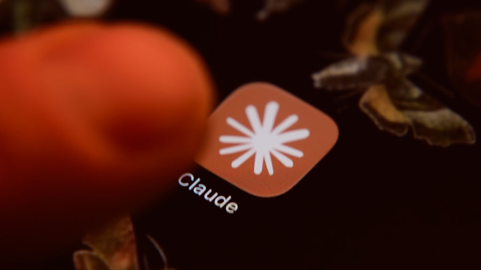 The Claude app icon is displayed on a smartphone screen with a finger about to tap it, in Creteil, France, on June 10, 2026. Anthropic announces the release of two new Mythos-class artificial intelligence models for cybersecurity and biomedical research, targeting both consumers and businesses. (Photo by Samuel Boivin/NurPhoto via Getty Images)