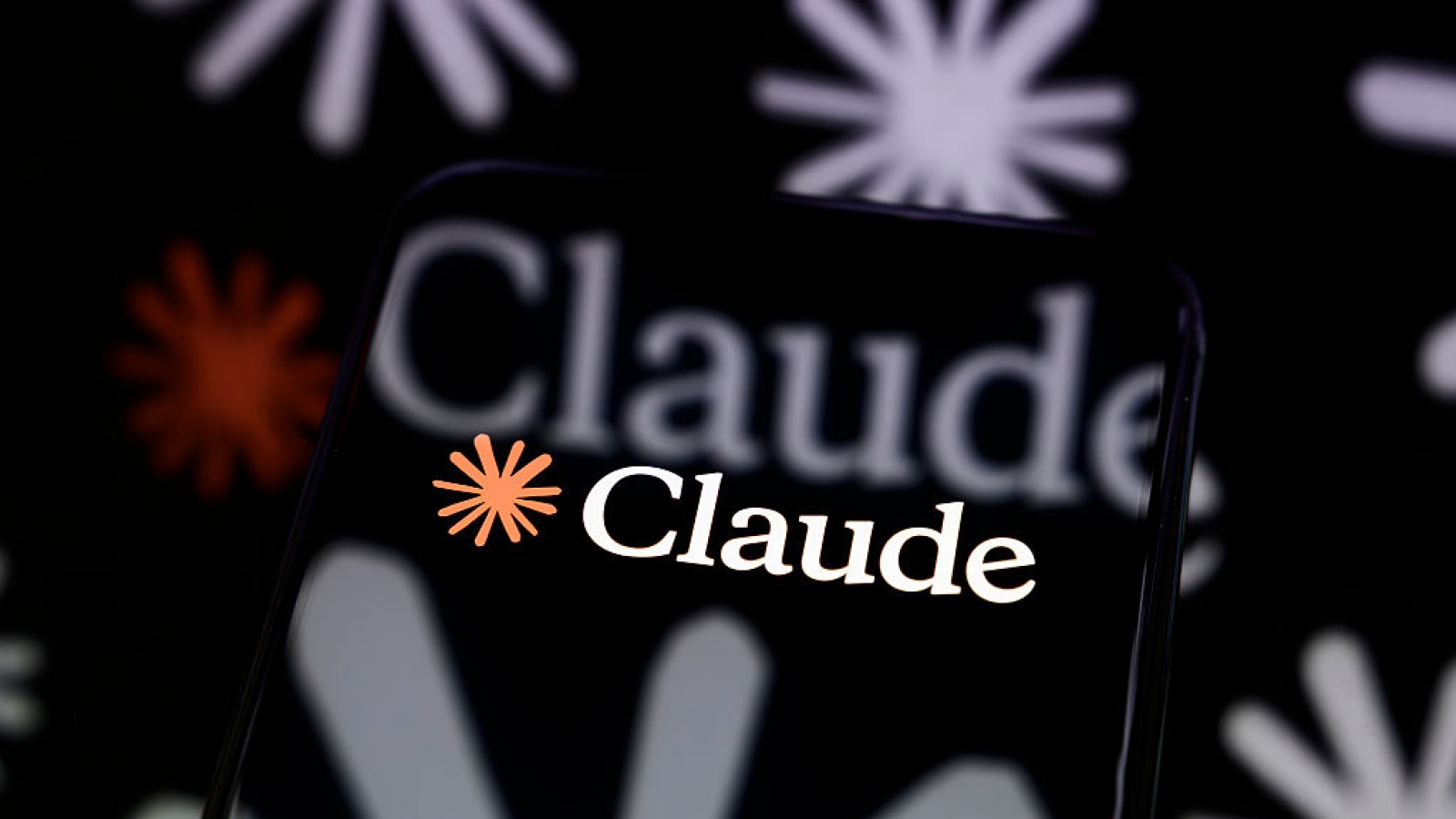 The Claude logo is displayed on a smartphone screen placed on a reflective surface onto which a multitude of Claude logos are projected, in Creteil, France, on April 8, 2026. Anthropic has announced the launch of Project Glasswing, a cybersecurity initiative based on the Claude Mythos model to detect and correct vulnerabilities in critical open-source software. (Photo by Samuel Boivin/NurPhoto via Getty Images)